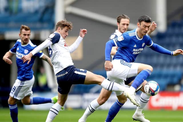 PNE midfielder Ryan Ledson puts in a challenge against Cardiff