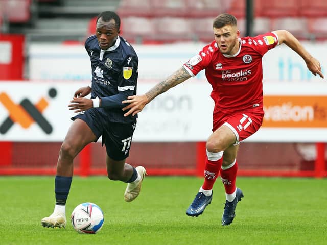 Morecambe's Carlos Mendes Gomes (left) and Crawley Town's Tyler Frost battle for the ball