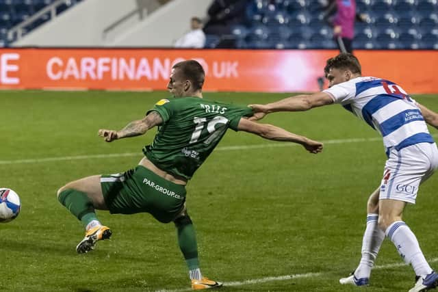 PNE striker Emil Riis is pulled back by QPR's Rob Dickie but no penalty was given