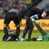 PNE midfielder Daniel Johnson is treated for cramp at QPR by physio Matt Jackson