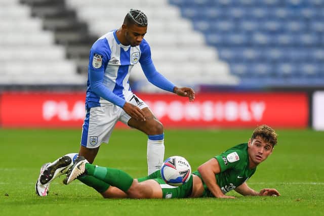 Preston North End’s Ryan Ledson is tackled by Huddersfield Town’s Juninho Bacuna