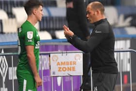 PNE manager Alex Neil gives some instructions to Josh Harrop before introducing him as a substitute at Huddersfield