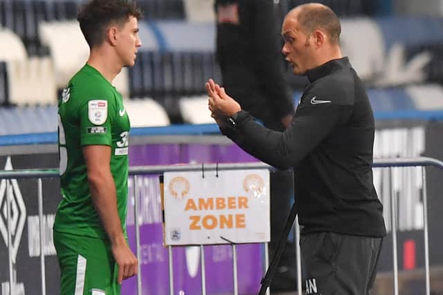 PNE manager Alex Neil gives some instructions to Josh Harrop before introducing him as a substitute at Huddersfield