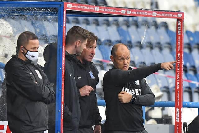 PNE manager Alex Neil with Steve Thompson and Paul Gallagher in the dugout at Huddersfield