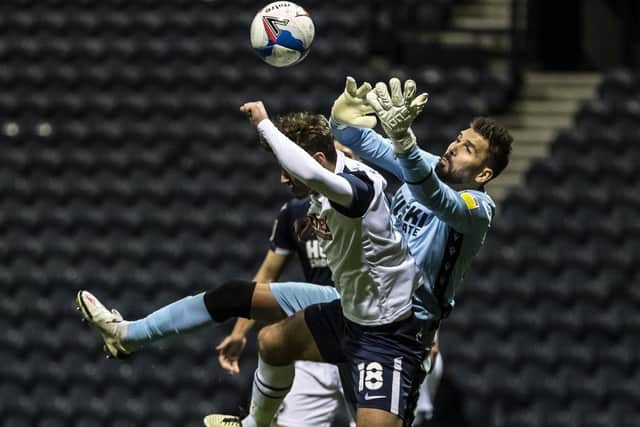 PNE midfielder Ryan Ledson challenges the Millwall goalkeeper