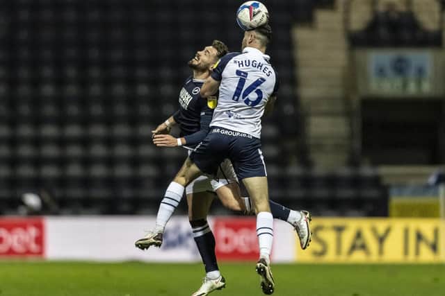 Andrew Hughes challenges in the air against Millwall