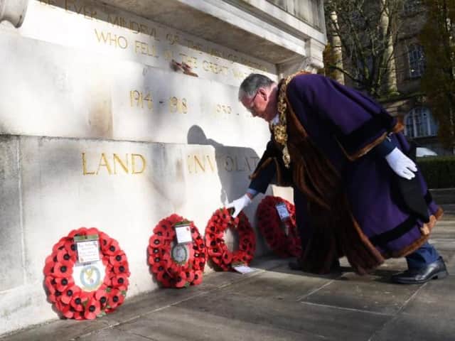 Mayor of Preston Coun David Borrow lays a wreath at the city's War Memorial.