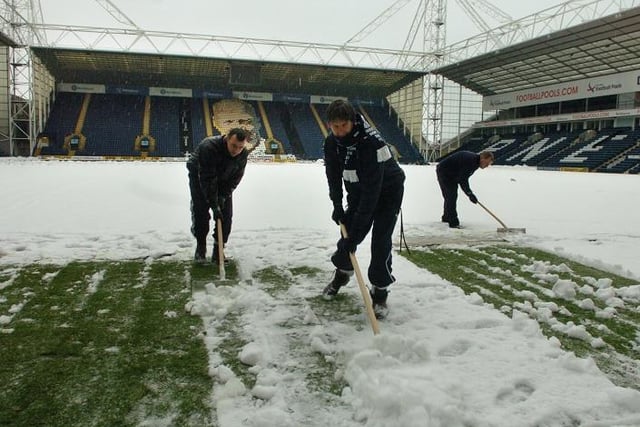 Volunteers and grounds staff snow clearing to get the game on at Deepdale, on December 28th