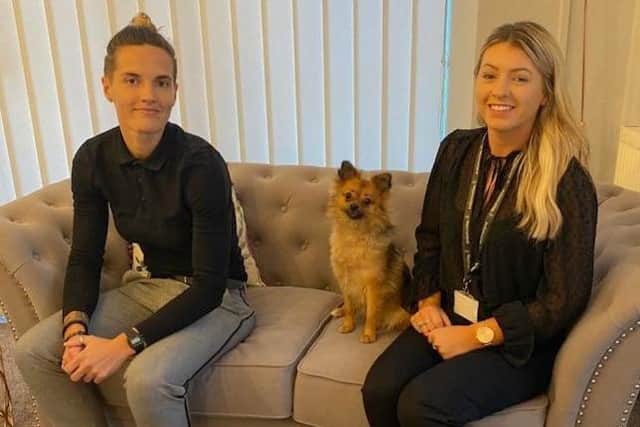 Pictured at the new Lancaster office are (from left) Lucy Trusler, a client coordinator and Christie Parker, care manager. Also pictured is Lucy's dog, Nala, a welcome visitor to the office.