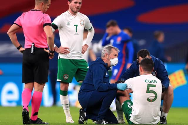 Alan Browne watches as Republic of Ireland team-mate John Egan receives treatment for a head injury