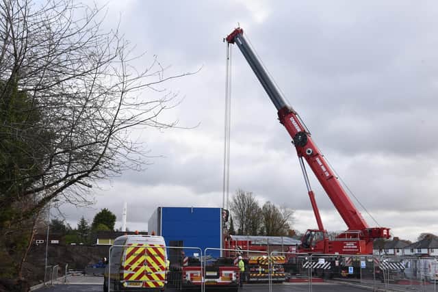 A crane moving the self-service petrol pumps on site