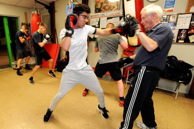 Andy Sumner (right) puts a young boxer through his paces at Preston and Fulwood Boxing Club