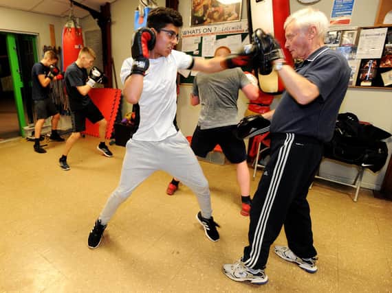 Andy Sumner (right) puts a young boxer through his paces at Preston and Fulwood Boxing Club