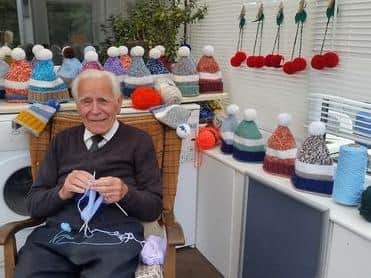 Arthur pictured with some of the hats he has made recently