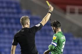 Preston North End's Alan Browne receives a yellow card from referee John Brooks  against Reading