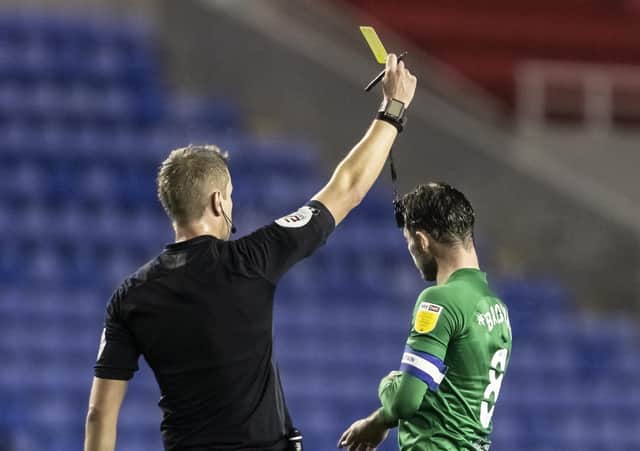 Preston North End's Alan Browne receives a yellow card from referee John Brooks against Reading