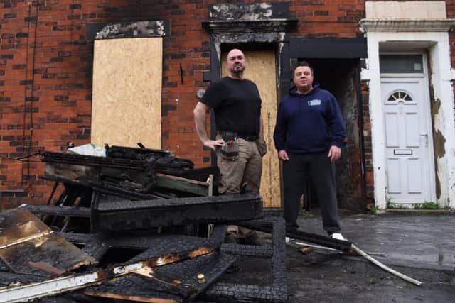 David Hardman, 50 (left) and Andy Wilson, 46, outside their neighbour's fire ravaged home in Boundary Street, Leyland where they rescued a young mum and her 12-year-old son yesterday afternoon (November 19)