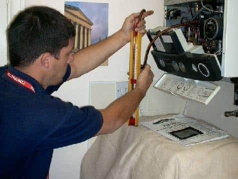 A gas engineer checking a domestic boiler