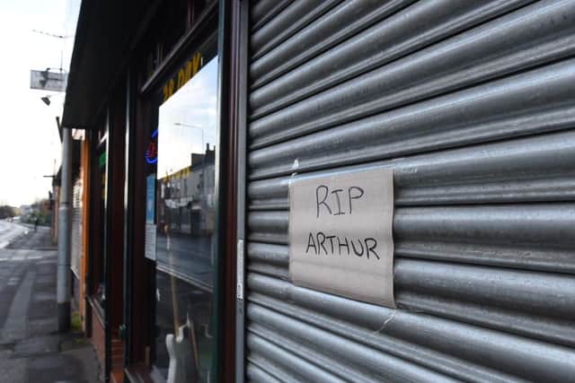 A sign and flowers have been left by locals outside Uncle's Pawnbrokers, Ribbleton Lane in memory of Arthur