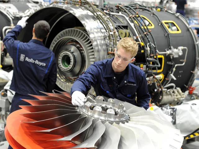 Rolls Royce staff working on fan blades for aircraft engines