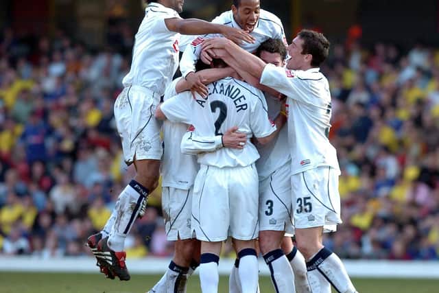 The North End players mob Paul McKenna after his goal at Watford