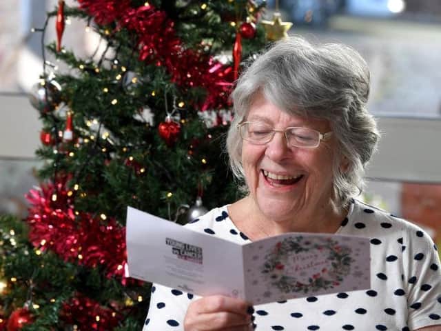 Grove House resident Maureen Finley reads one of her Christmas cards