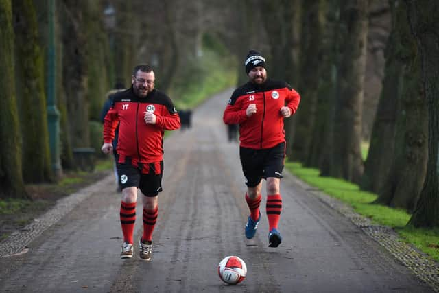 Yanny Tsimboykas and Scott Shaw of OKFC on the team’s sponsored Guild Wheel dribble