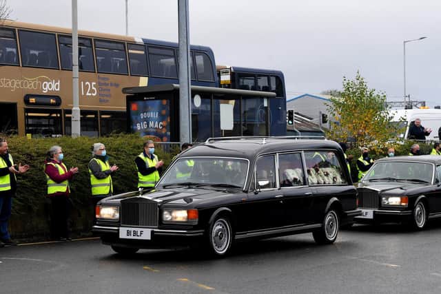 The hearse passes by as colleagues clap at Chorley bus station