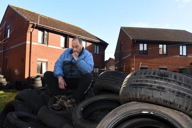 Neil Black on the mound of tyres in his garden