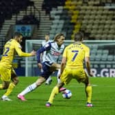 Brad Potts shields the ball from Wycombe Wanderers' Nick Freeman and David Wheeler