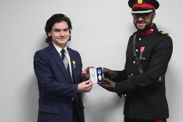Monty is presented with his BCyA medal by HM Deputy Lieutenant of Greater Manchester, Saeed Atcha at his school
