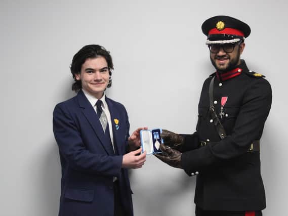Monty is presented with his BCyA medal by HM Deputy Lieutenant of Greater Manchester, Saeed Atcha at his school