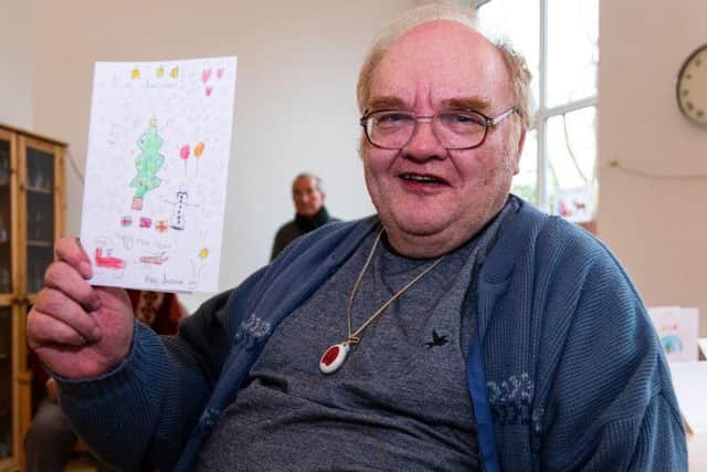 George Marshall, 70, holding the Christmas card he received.