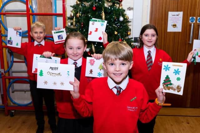 Left to right - Ruslans Stefanovics, Tia Clements, Jacob Tidswell and Elsie Sweatman from Kirkham County Primary School with the cards they received from the care home