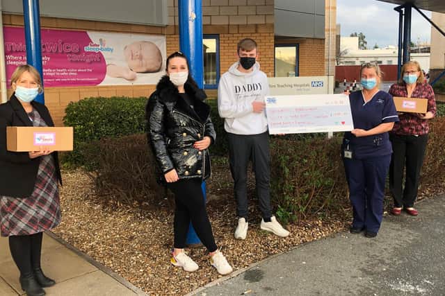 Ross and his sister Lauren donating the cheque to staff at Preston hospital
