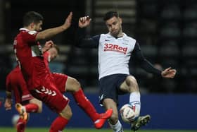 Preston North End left-back Andrew Hughes is challenged by Middlesbrough's Sam Morsy