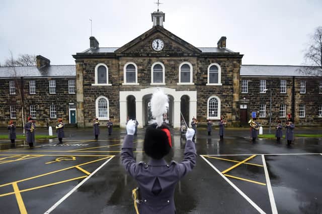The Lancashire Artillery Volunteers band perform a socially distanced Christmas concert in front of the 18th century listed archway at Fulwood Barracks