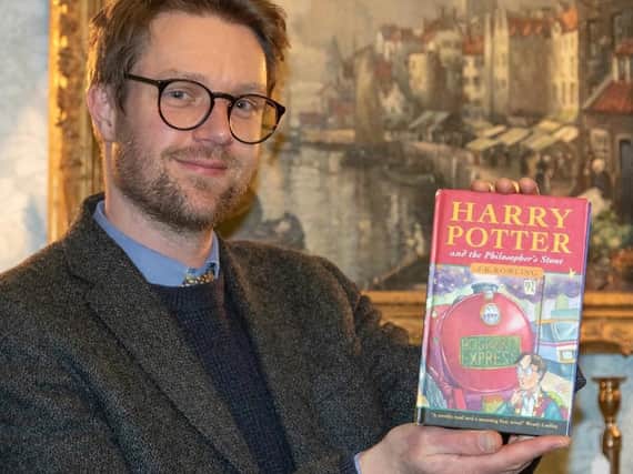 Hansons’ books expert Jim Spencer with the first edition. The Rumsey family, from Preston, found a long lost first edition of a Harry Potter book and were going to send it to a car boot sale before they realised it could be valuable. The first edition of Harry Potter and the Philosopher's Stone is set to be auctioned in December 2020 and could fetch £50,000. Picture courtesy Mark Laban/Hansons Auctioneers