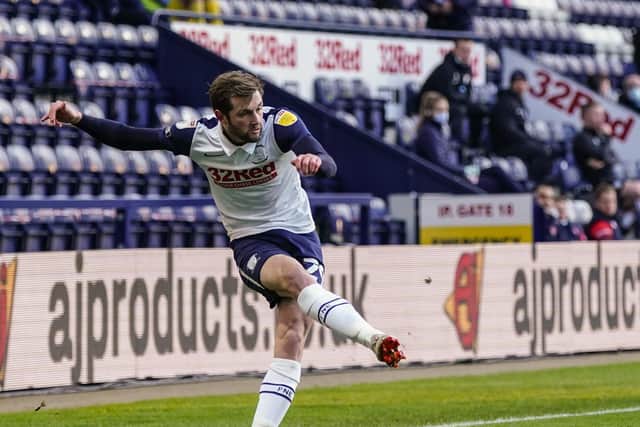 North End's Tom Barkhuizen crosses the ball against Wycombe at Deepdale