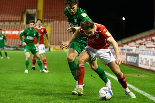 PNE left wing-back Josh Earl tussles with Barnsley's Callum Brittain