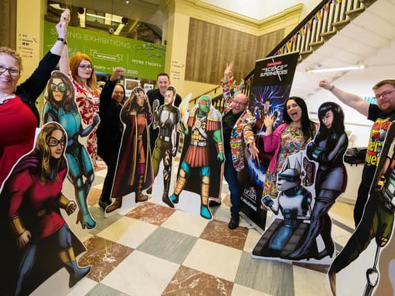 The seven Unmasked: Science of Superheroes authors with their cardboard cut-outs at the official book launch