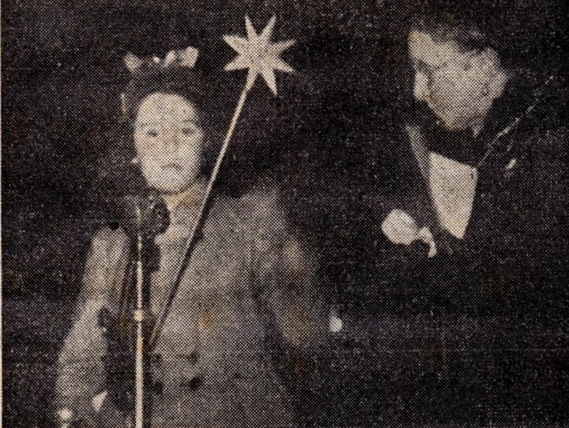 Fairyland touch: Wand in hand, Miss Anne Langley, watched by the mayoress of Morecambe (Mrs W Curwen), switched on Morecambe's illuminated Christmas tree tableau.
