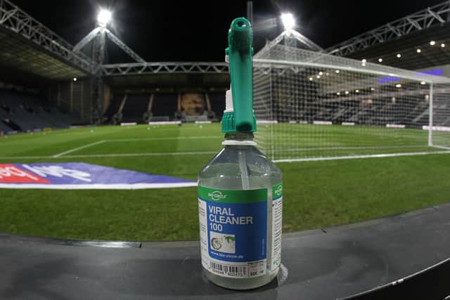 Football 2020 style - a bottle of sanitiser is placed next to the pitch at an empty Deepdale
