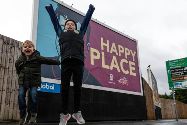 Jordan North's nephews (l-r) Seb and Austin outside the billboard at Turf Moor, Burnley. Photo: Kelvin Stuttard