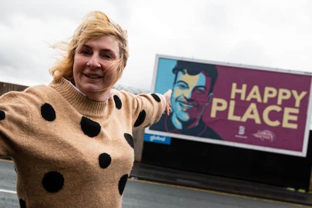 Jordan North's mum Wendy North next to the billboard of her son at Turf Moor, Burnley. Photo: Kelvin Stuttard