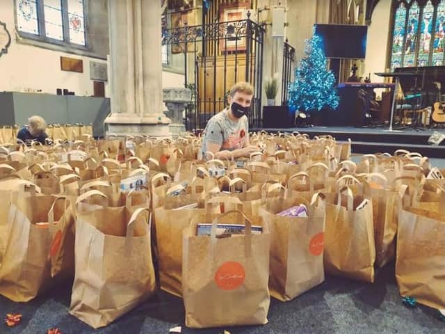 Ethan Noble helping to prepare the Christ,mas parcels at the Minster.
