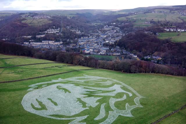 An aerial view shows an artwork entitled '6000 Children' by local art collective 'Sand In Your Eye', in Hebden Bridge