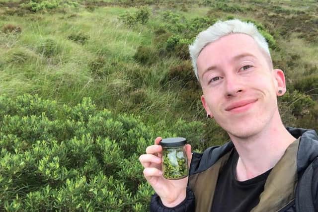 Josh Styles pictured holding a jar of seeds from the Bog Myrtle (Myrica gale)