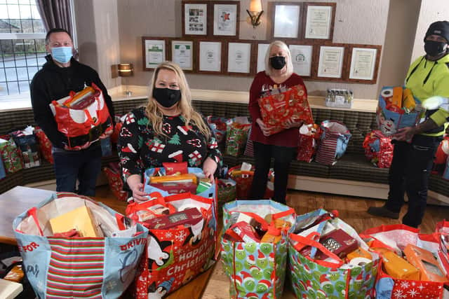 Photo Neil Cross; Kevan Williams, Claire Hewitson, Karen Taylor and Lewis Buller, of Find-a-Friend Christmas Dinner, with the hampers
