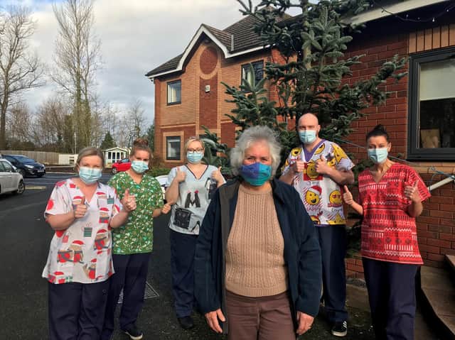 Pat with Derian House staff in their new festive scrubs